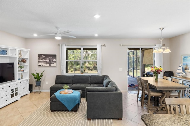 living room with recessed lighting, baseboards, and light tile patterned flooring