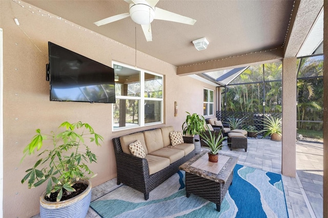 view of patio / terrace with a lanai, ceiling fan, and an outdoor living space