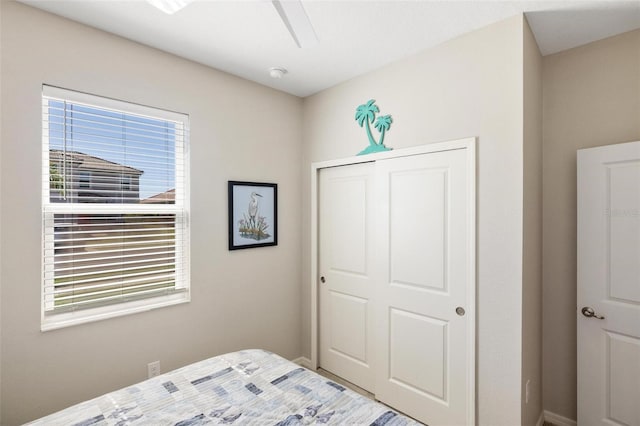 bedroom featuring a ceiling fan and a closet