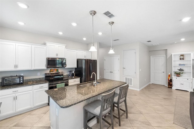 kitchen with a toaster, visible vents, white cabinets, stainless steel appliances, and a sink