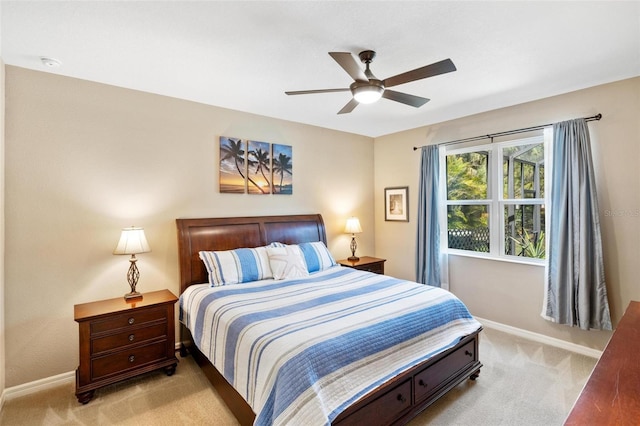 bedroom featuring a ceiling fan, light carpet, and baseboards