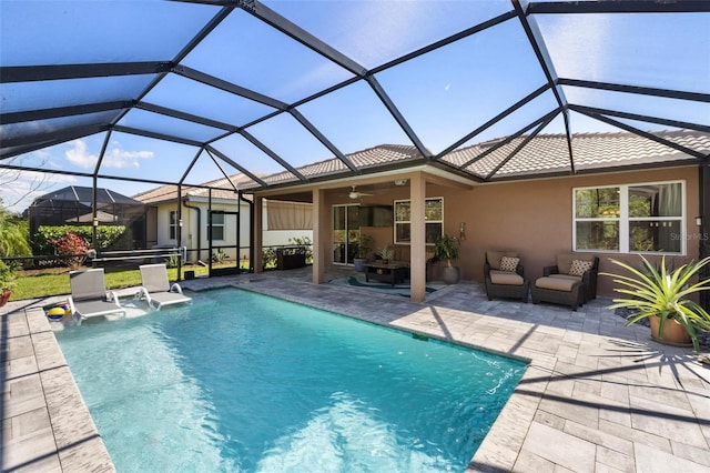 pool featuring outdoor lounge area, a patio area, a lanai, and a ceiling fan