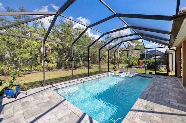 pool featuring glass enclosure and a patio