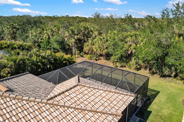 exterior space with a view of trees and a yard