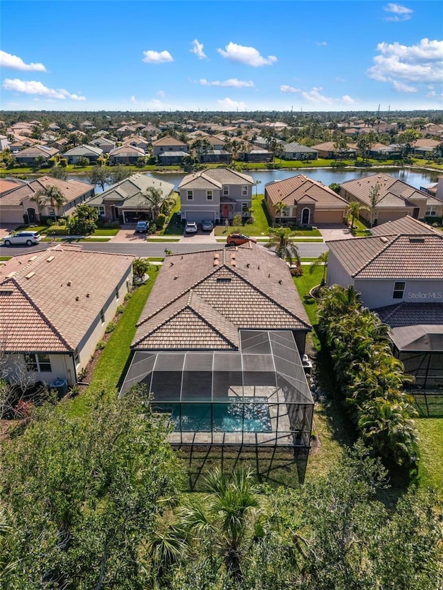 drone / aerial view featuring a residential view and a water view