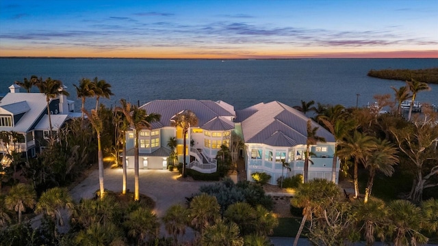 aerial view at dusk with a water view