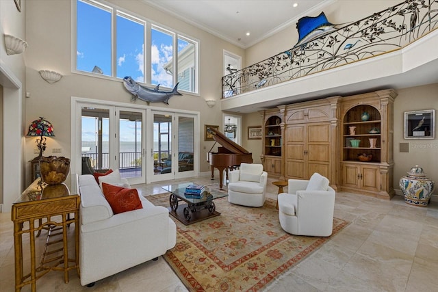 living area featuring ornamental molding, french doors, a towering ceiling, and baseboards