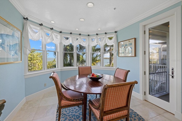 dining room featuring plenty of natural light, light tile patterned flooring, and baseboards