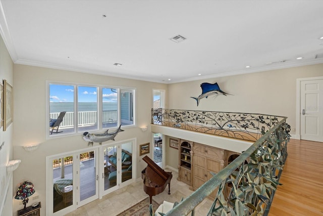 hall featuring recessed lighting, visible vents, baseboards, ornamental molding, and light wood finished floors