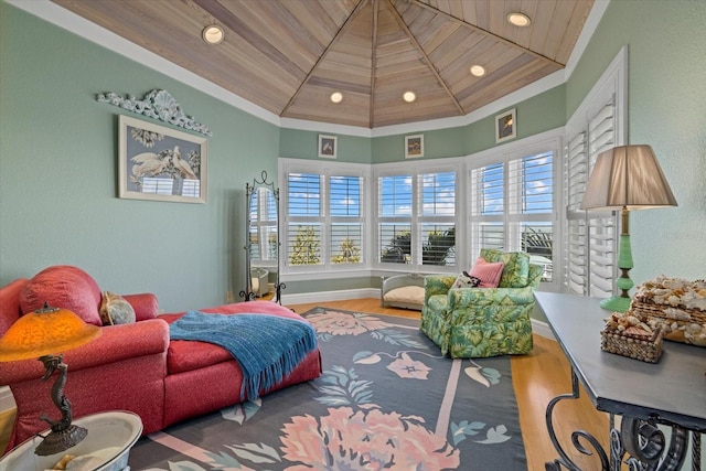 bedroom with ornamental molding, wood finished floors, and wood ceiling