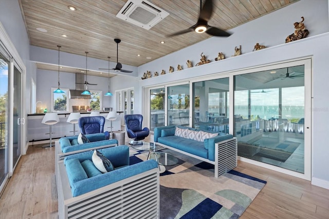 sunroom featuring ceiling fan, a wealth of natural light, and wood ceiling