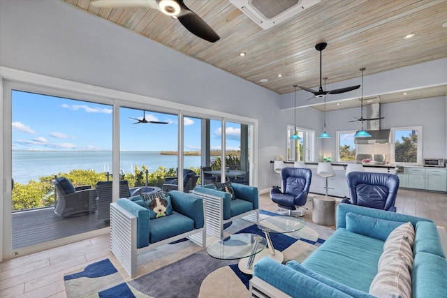 living room featuring wooden ceiling, a water view, plenty of natural light, and light wood-style flooring