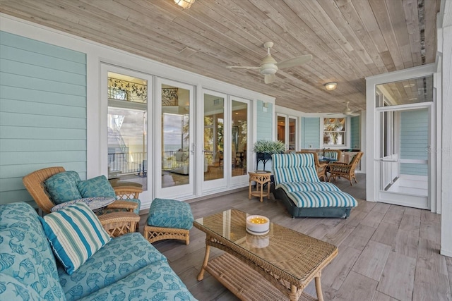 sunroom featuring a ceiling fan and wooden ceiling