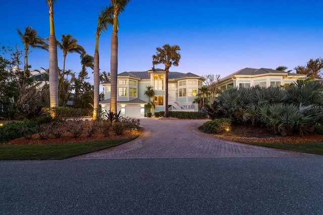 view of front of house featuring an attached garage and decorative driveway