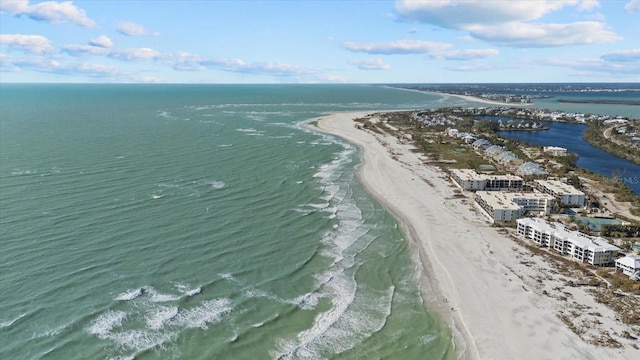 drone / aerial view featuring a water view and a beach view