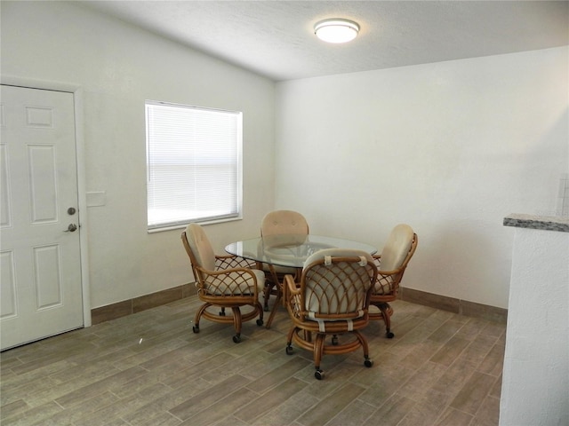 231 Redwood Rd, Venice, FL 34293 - dining area with a textured ceiling, baseboards, and wood finished floors