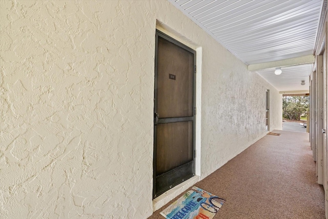 property entrance with stucco siding