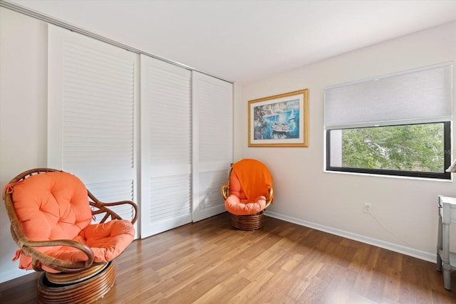 sitting room featuring light wood-style flooring and baseboards