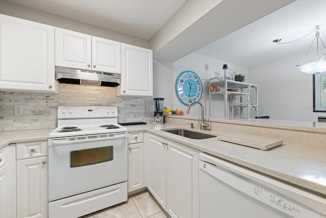 kitchen with white appliances, a sink, under cabinet range hood, white cabinetry, and backsplash