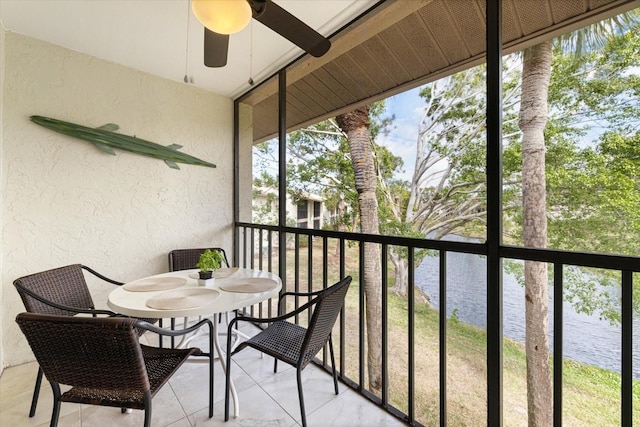 balcony with a ceiling fan and a water view