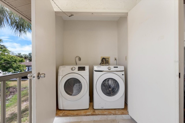 clothes washing area featuring laundry area and washing machine and clothes dryer