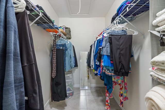 walk in closet featuring attic access