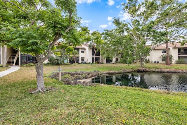 view of yard featuring a water view and stairs