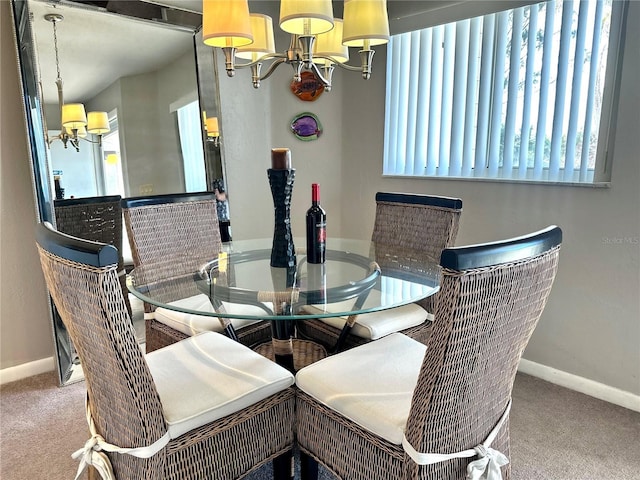 carpeted dining room with baseboards and an inviting chandelier