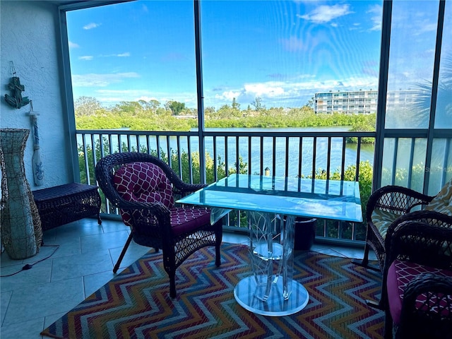 sunroom / solarium with a water view