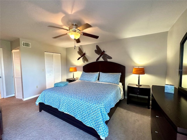 carpeted bedroom with baseboards, visible vents, ceiling fan, and a closet