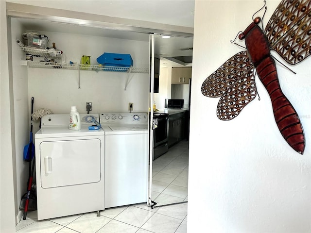 washroom featuring light tile patterned floors, laundry area, and washer and dryer