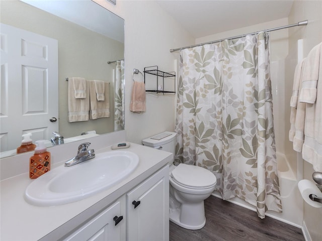 bathroom featuring shower / bath combination with curtain, vanity, toilet, and wood finished floors