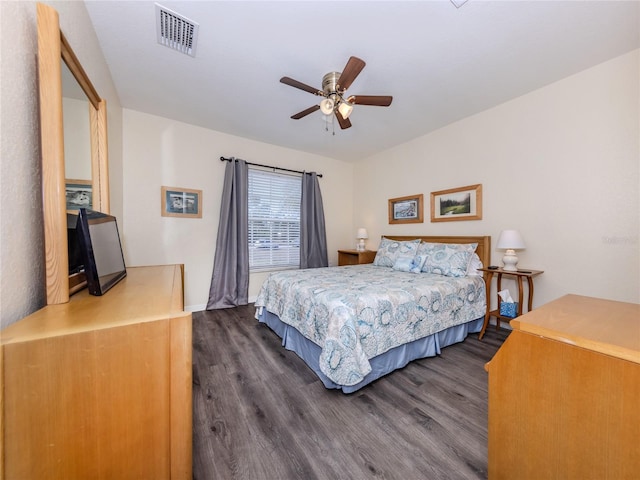 bedroom with wood finished floors, visible vents, and a ceiling fan