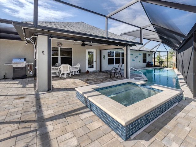 view of swimming pool with area for grilling, a pool with connected hot tub, a patio area, and a ceiling fan