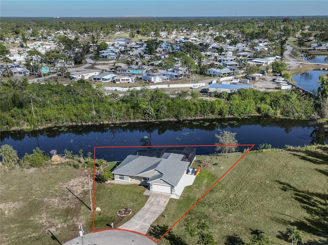 birds eye view of property with a water view and a residential view