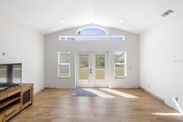 doorway to outside with french doors, recessed lighting, visible vents, light wood-style floors, and vaulted ceiling