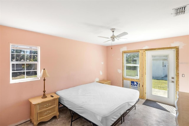 bedroom featuring access to exterior, ceiling fan, visible vents, and concrete flooring