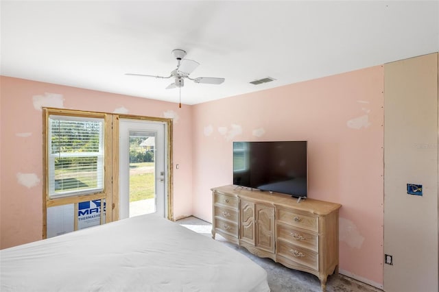 bedroom with a ceiling fan, light colored carpet, visible vents, and access to exterior