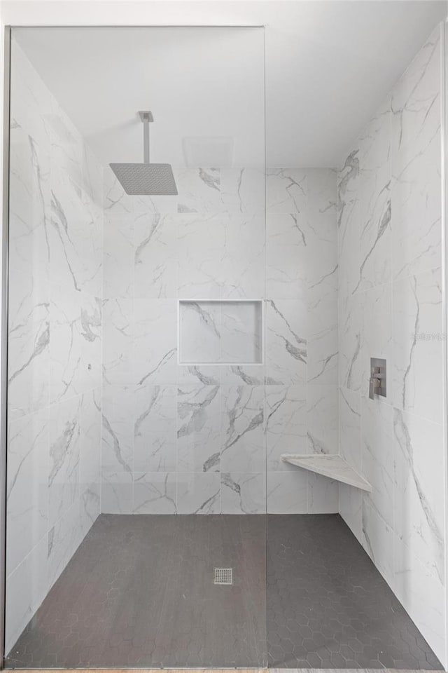 interior space featuring a marble finish shower