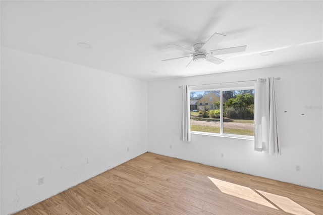 empty room with light wood finished floors and ceiling fan