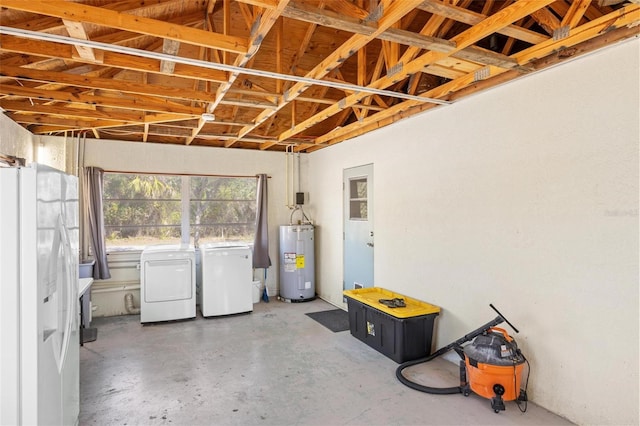 garage with white fridge with ice dispenser, washing machine and dryer, and electric water heater