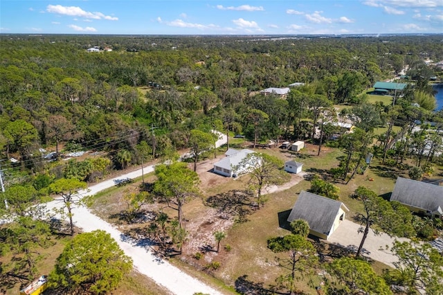 birds eye view of property with a wooded view