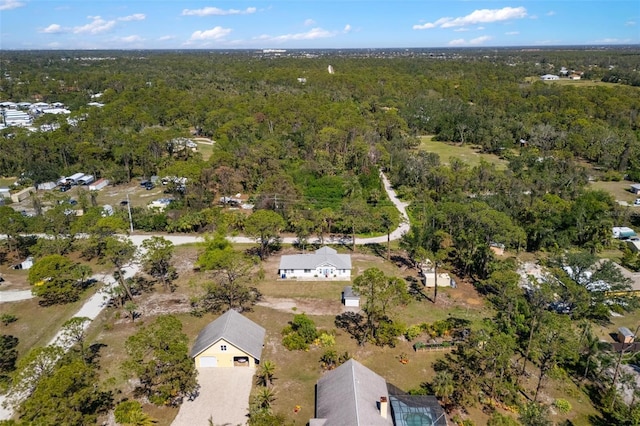 drone / aerial view featuring a view of trees