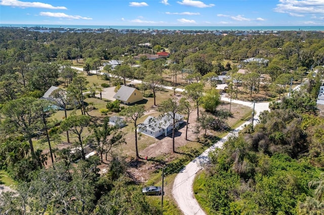 aerial view featuring a forest view and a water view