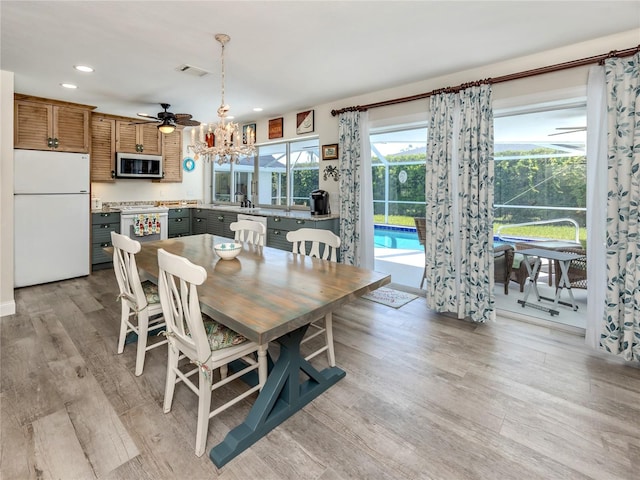601 Apalachicola Rd, Venice, FL 34285 - dining area with recessed lighting, light wood finished floors, a chandelier, and ceiling fan