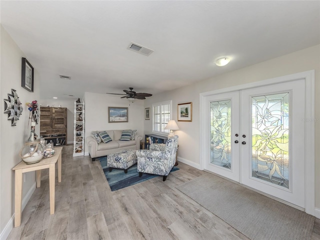 601 Apalachicola Rd, Venice, FL 34285 - living area featuring baseboards, light wood-type flooring, ceiling fan, and french doors