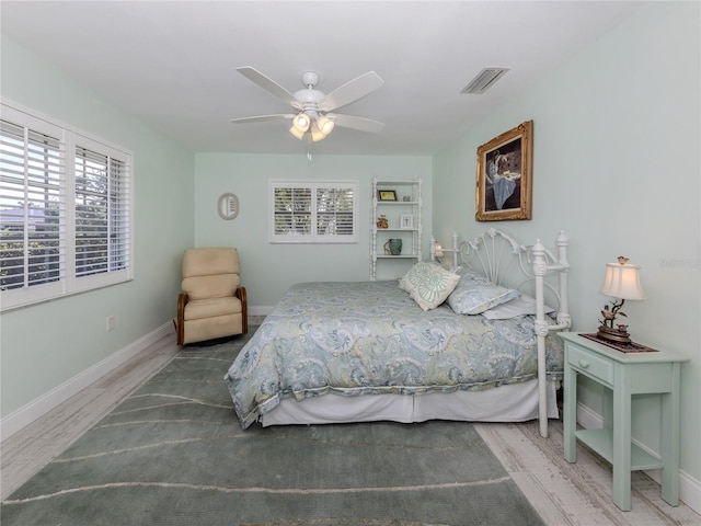 601 Apalachicola Rd, Venice, FL 34285 - bedroom featuring wood finished floors, multiple windows, baseboards, and a ceiling fan