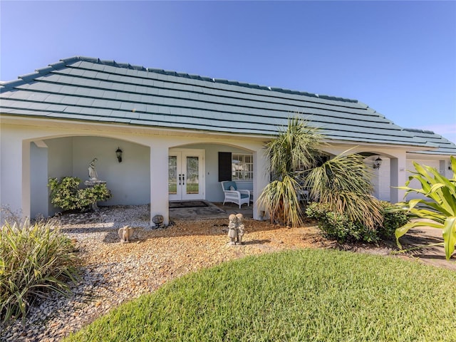 601 Apalachicola Rd, Venice, FL 34285 - view of front facade featuring french doors and stucco siding