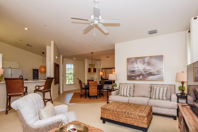 living room with lofted ceiling, recessed lighting, light colored carpet, visible vents, and ceiling fan