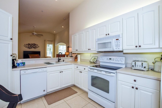 kitchen featuring light countertops, white appliances, light tile patterned flooring, and white cabinets